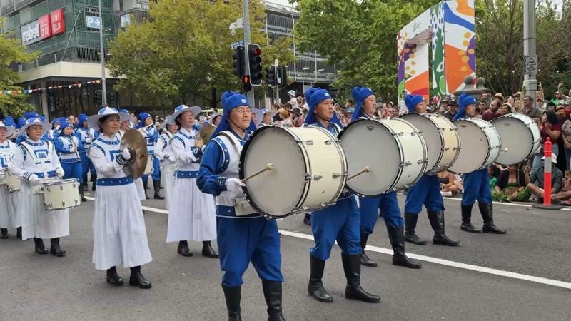 The full band in formation on a Canberra city street